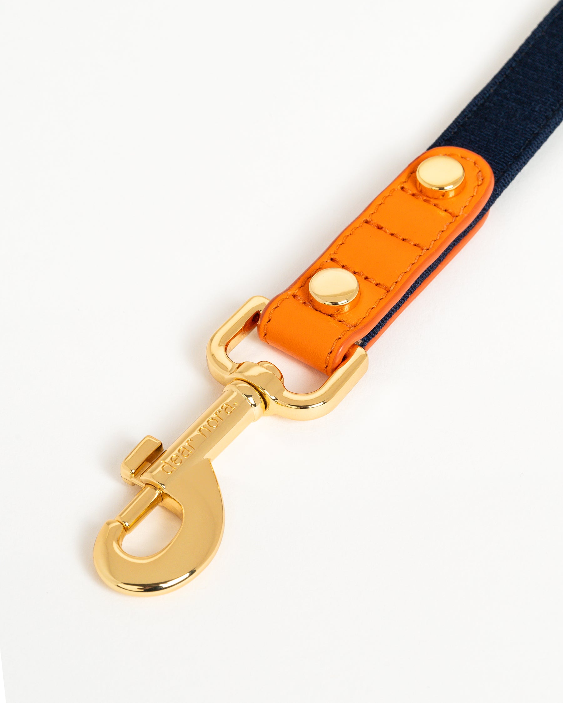 Dear Nora Tangerine dog leash hook - orange leather, navy blue fabric and 24k plated hardware - close up shot