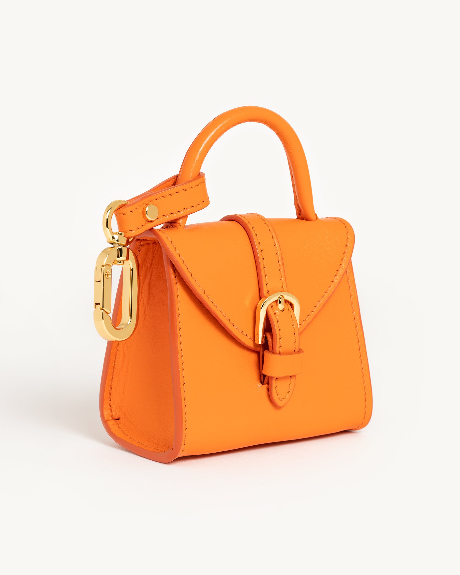 Dear Nora Tangerine poop bag holder - orange leather and 24k plated hardware - three quarter angle shot