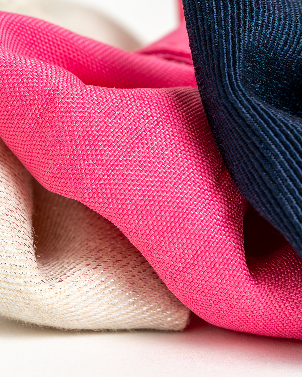 Close up of Dear Nora fabrics - cream glitter, pink and navy blue